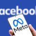 Moscow - 29 Oct, 2021: Meta logo on screen of mobile phone on Facebook word background. Facebook after rebranding and changing name to Meta. Facebook is social networking. Marketing and trend concept